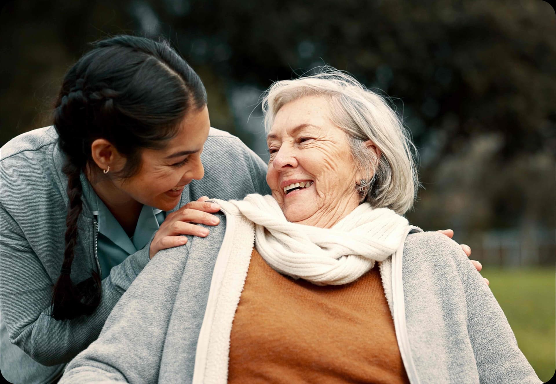 Care worker sharing a joyful moment with elderly client